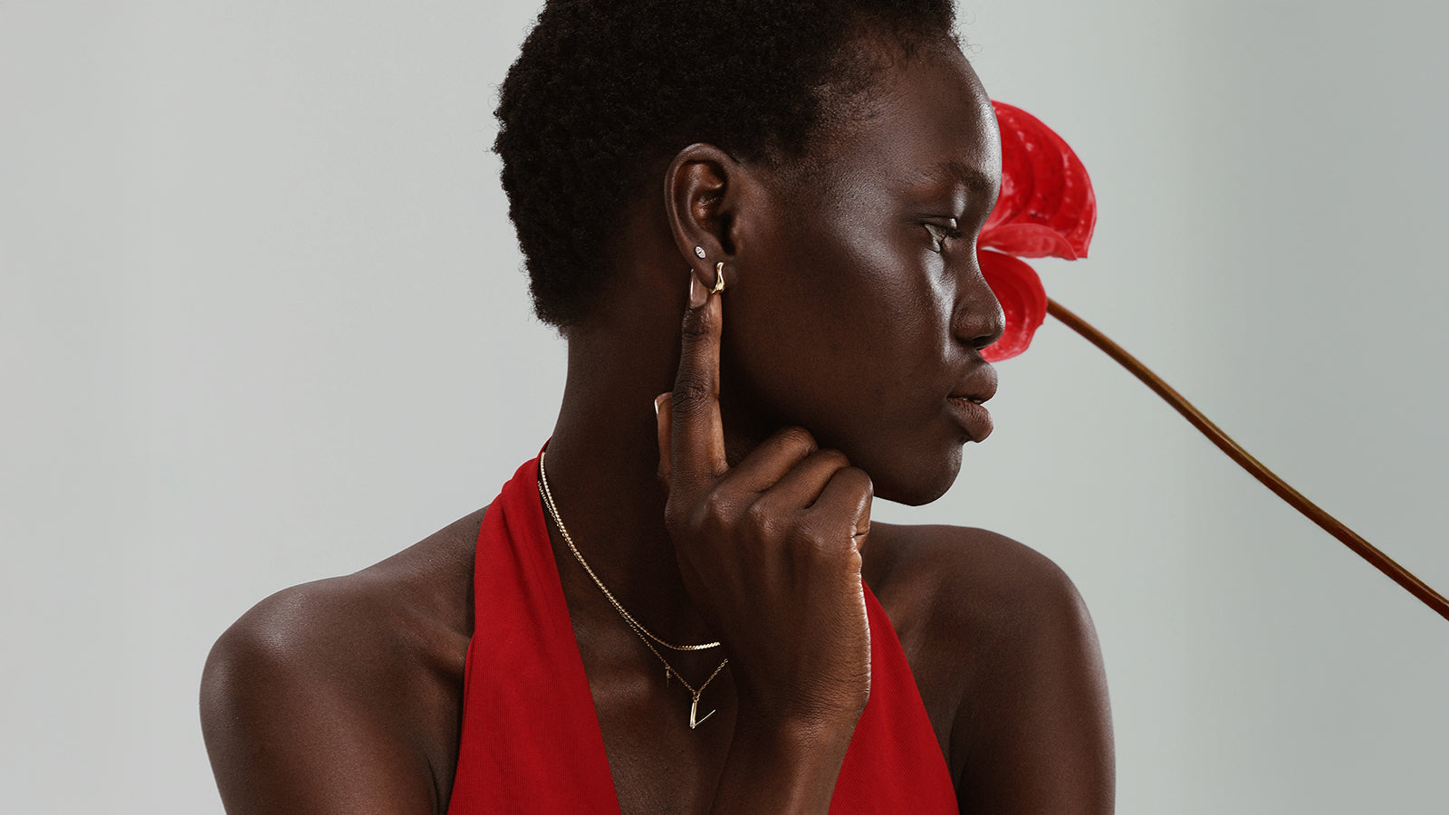 Model wearing quality gold stud earrings and piercing jewelry showcasing comfortable hypoallergenic materials for sensitive ears