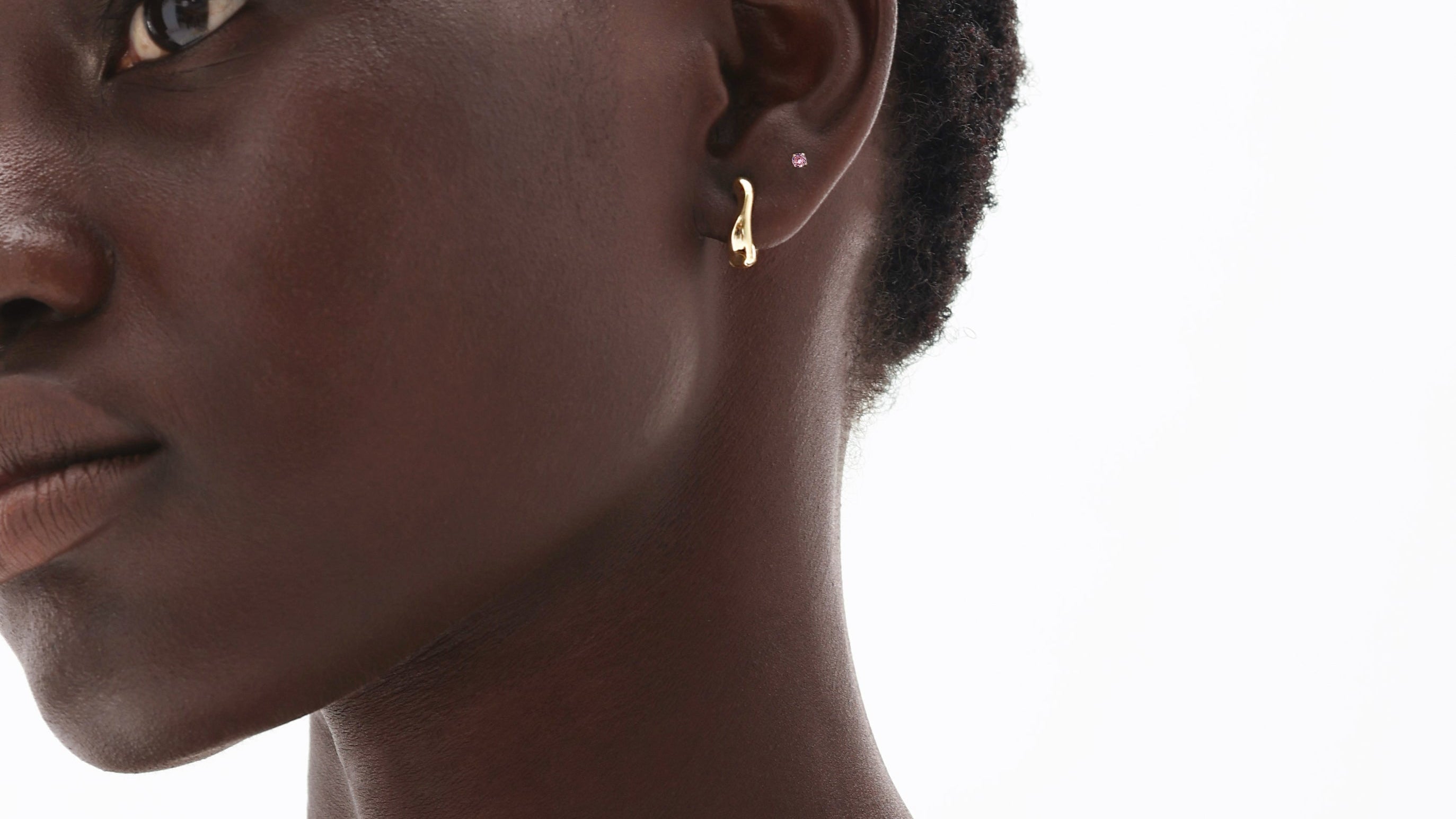 Woman wearing 14K solid gold pink tourmaline earrings and delicate chain necklace showcasing October birthstone jewelry