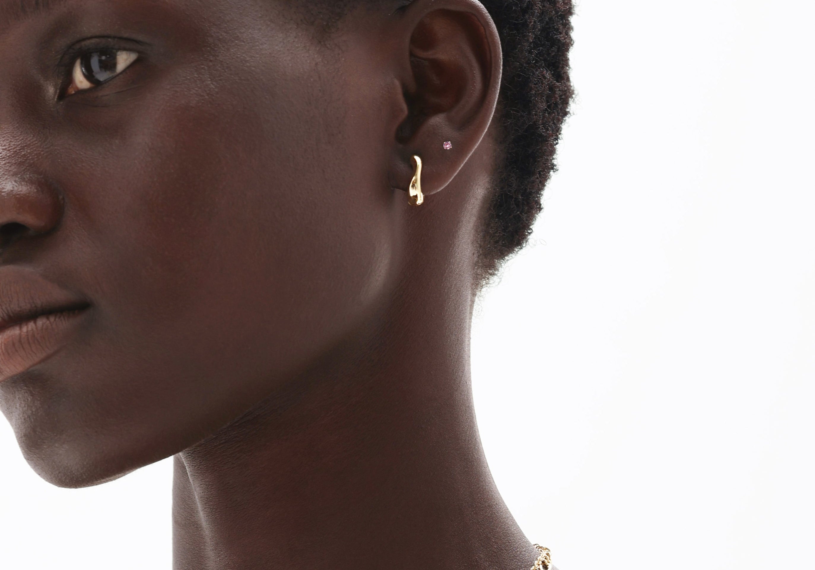 Woman wearing 14K solid gold pink tourmaline earrings and delicate chain necklace showcasing October birthstone jewelry