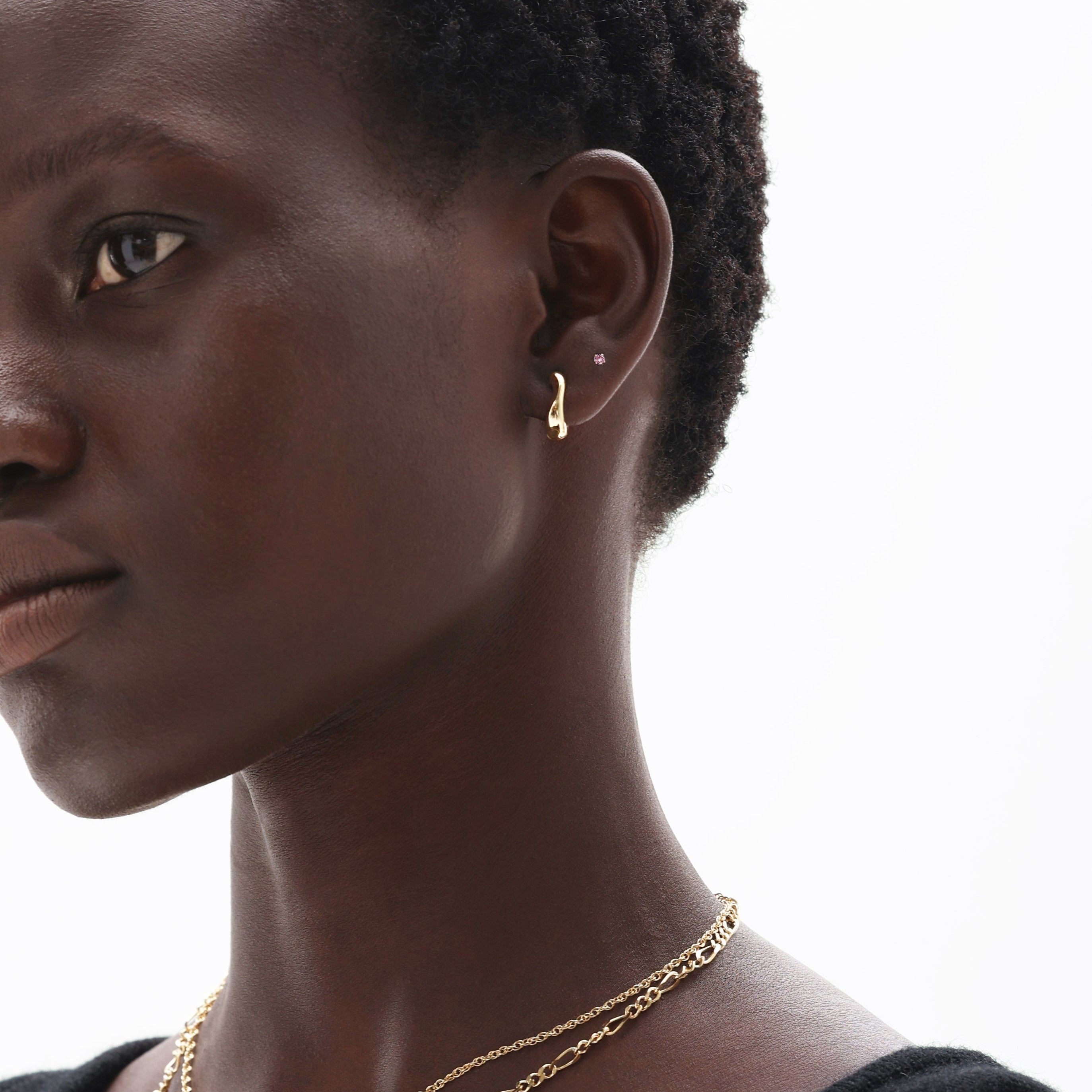 Woman wearing 14K solid gold pink tourmaline earrings and delicate chain necklace showcasing October birthstone jewelry