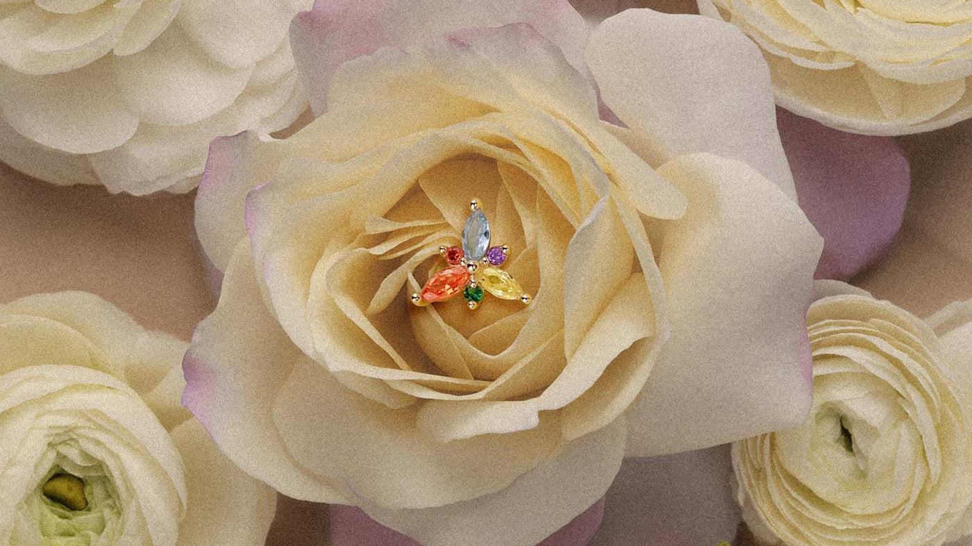 Multi-colored marquise gemstone cluster stud earring in gold set inside a flower for elegant cartilage or helix piercings.