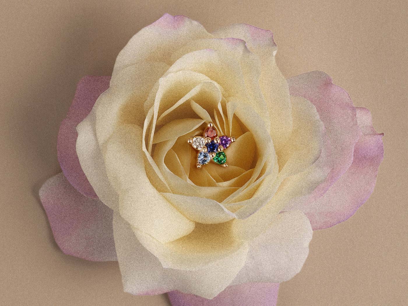 Colorful gemstone star stud earring in 14K gold nestled in cream rose for helix piercing jewelry inspiration