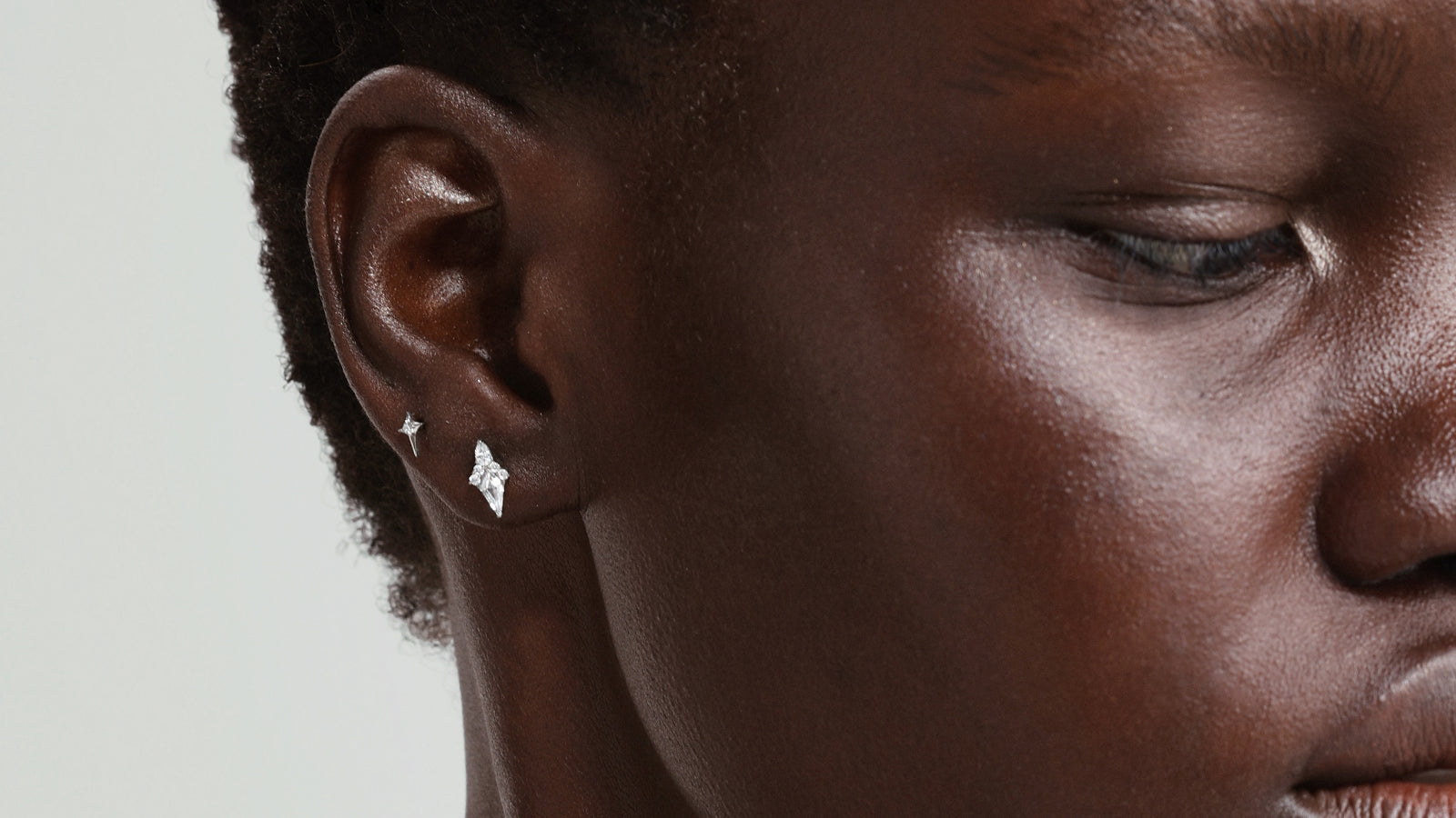 Minimalist silver ear studs featuring star and diamond shapes, ideal hypoallergenic jewelry for healing ear piercings.