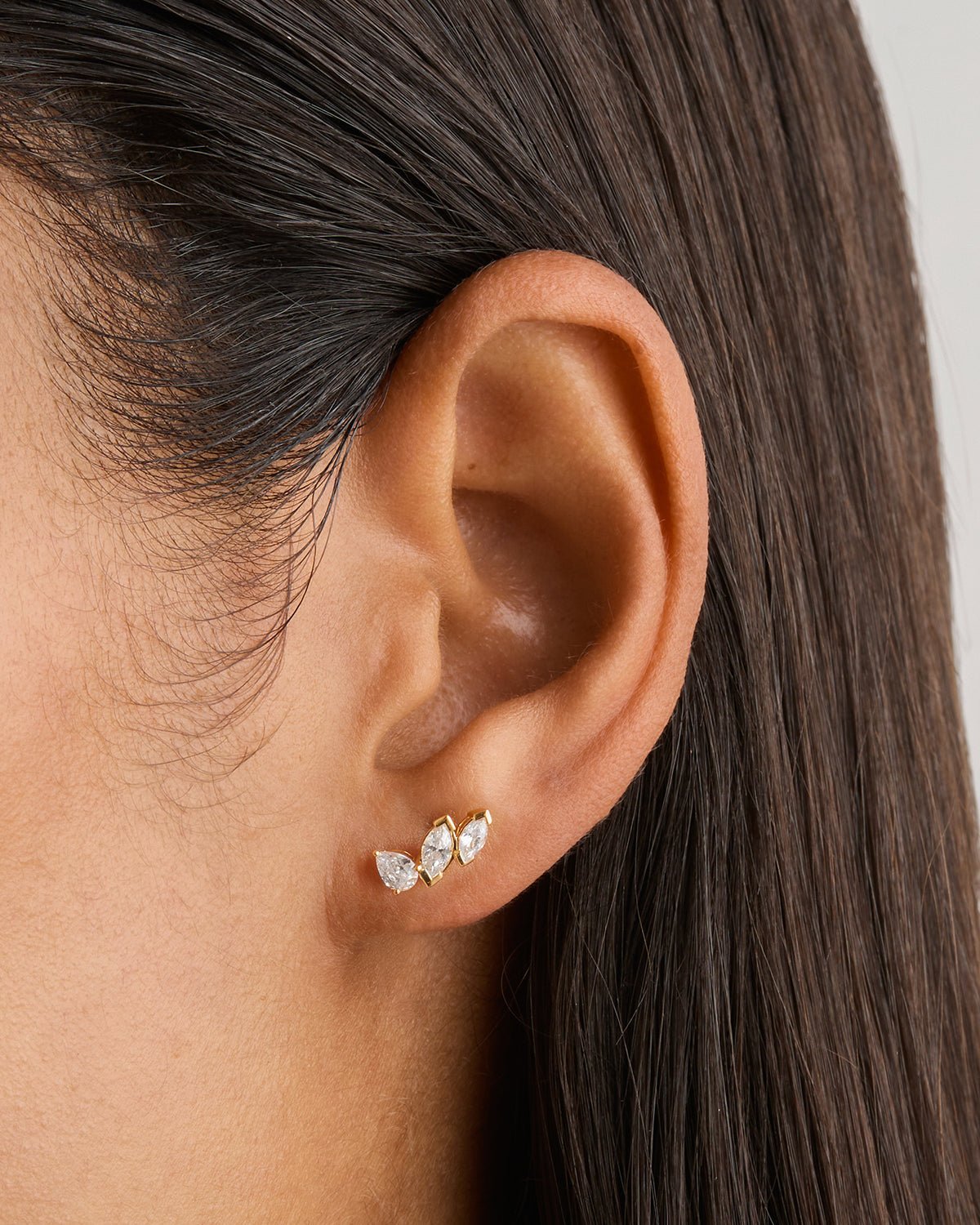 Kosiner jewelry Dainty gold hoop earrings styled on ear with layered piercings