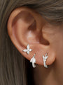 Sterling silver earring set with butterfly stud, pear & leaf CZ hoop earrings on ear, 18k gold plated.