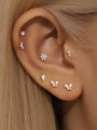 14K solid gold Losange zircon ear piercing stud with flat back closure on ear.