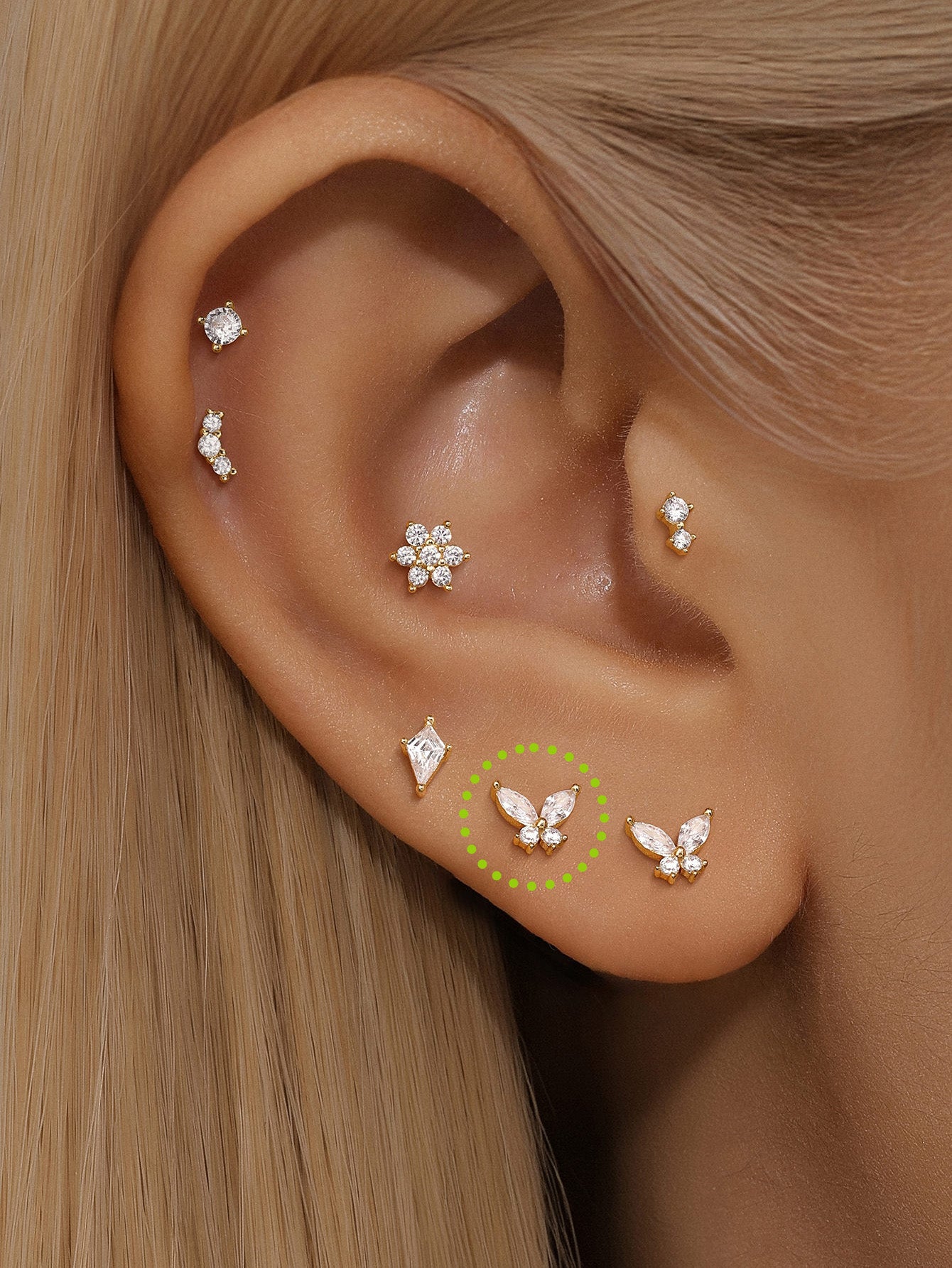 14K solid gold butterfly piercing studs with AAAAA cubic zirconia, styled in an ear stack.