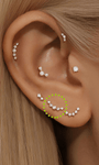 14K solid gold curved ear piercing stud with five cubic zirconia stones, shown on ear.