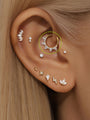 14K solid gold shiny claw hoop earring with prong-set marquise cubic zirconia stones, worn on ear.