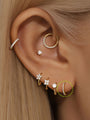 14K solid gold 8mm huggie hoop earring with pave AAAAA cubic zirconia, shown on ear.