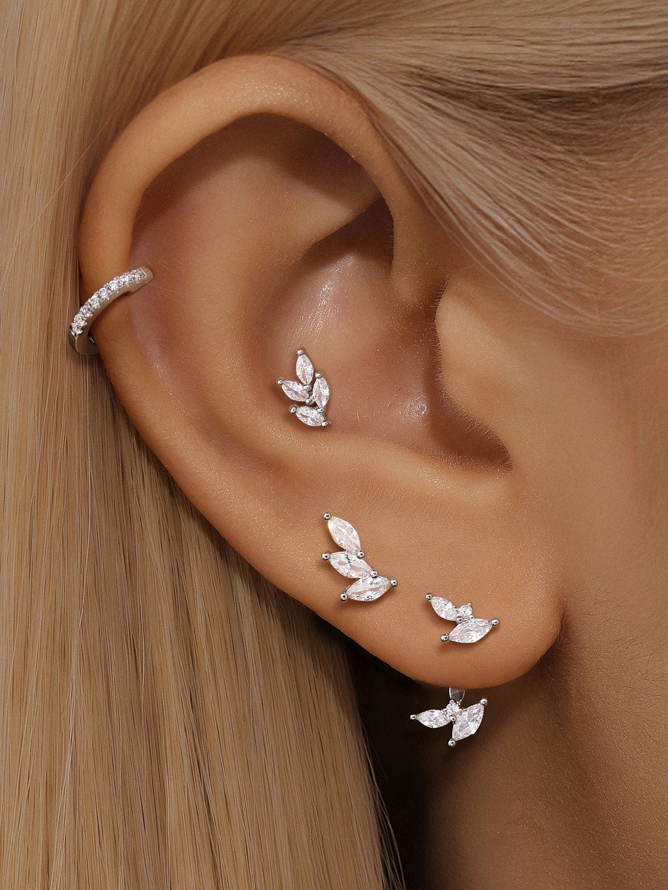 925 Sterling Silver Leaf Earrings with Cubic Zirconia on model's ear.