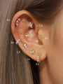 Gold 925 sterling silver earrings with cubic zirconia: butterflies, stars, leaves, floral designs on ear.