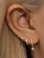 3pc sterling silver floral zircon hoop earrings on model's ear, showcasing pave details and charms.