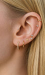 KOSINER 14K solid gold minimalist trinity stud worn solo or layered in curated ear stack
