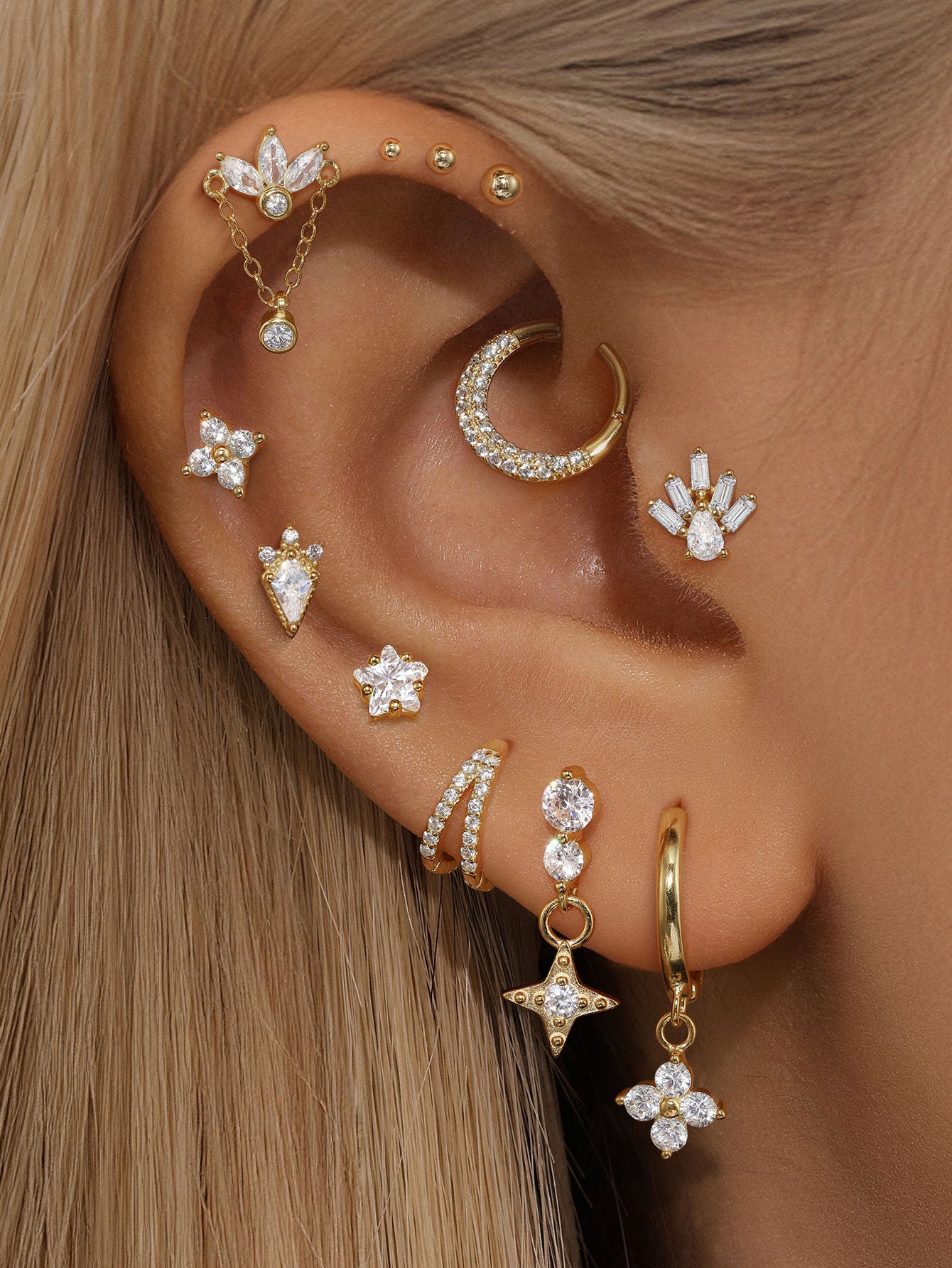 Earring set: 18kt gold plated sterling silver with geometric cubic zirconia studs, hoops, and drops.