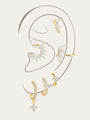 Gold plated sterling silver earrings with CZ. Features floral, moon & leaf designs on model's ear.