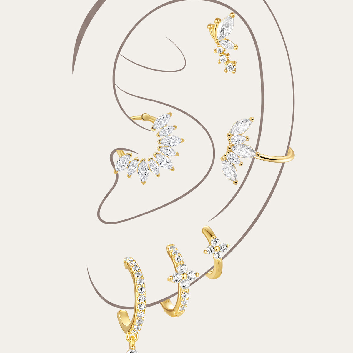 Gold plated sterling silver earrings with CZ. Features floral, moon & leaf designs on model's ear.