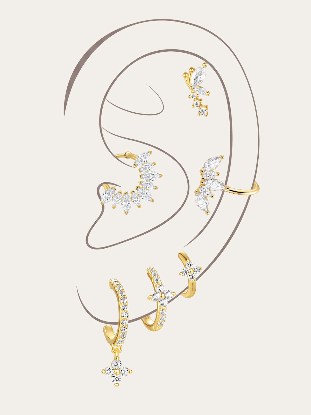 Gold plated sterling silver earrings with CZ. Features floral, moon & leaf designs on model's ear.
