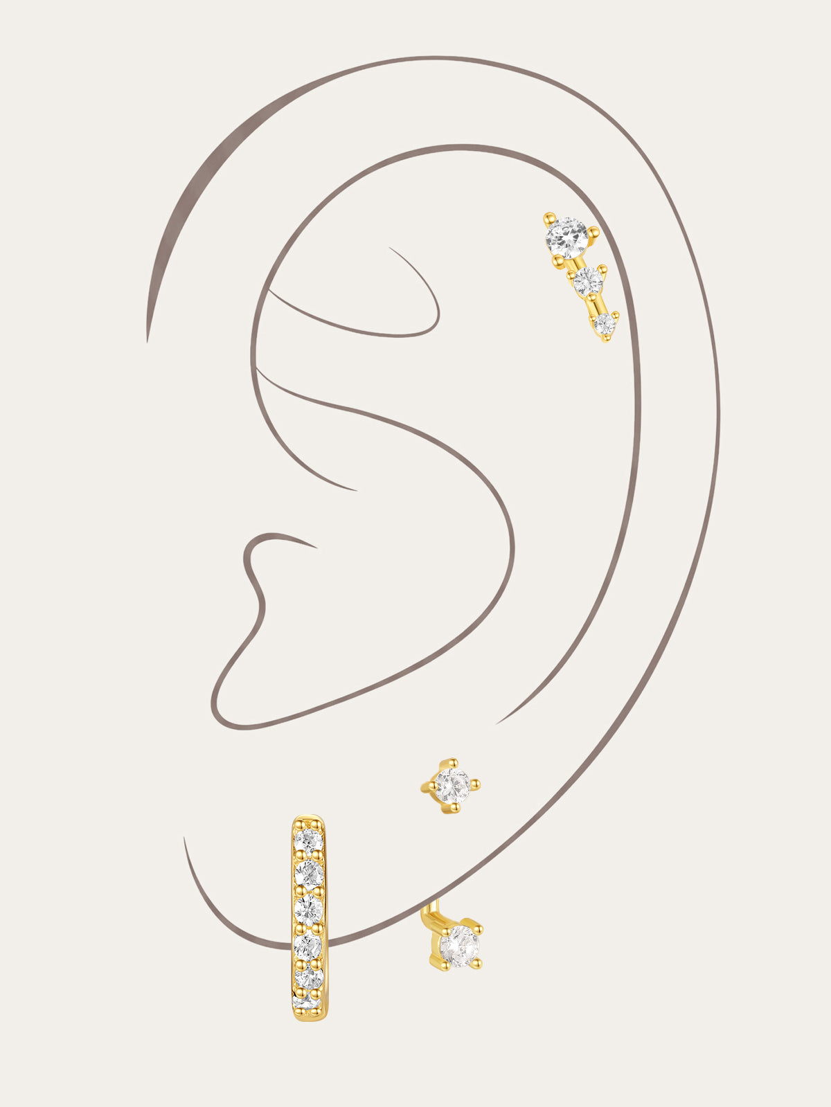 3-piece 18k gold-plated cubic zirconia earring set: hoop, ascending stud, square stud on a woman's ear.