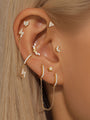 Gold plated 925 sterling silver Marquise Arch CZ threaded ear piercing stud. Delicate stud shown on ear with other styles.