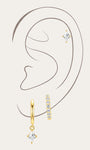 Model wearing 3-piece 18k gold-plated earrings: stud, hoop, and dangle, featuring quadrilateral cubic zirconia.