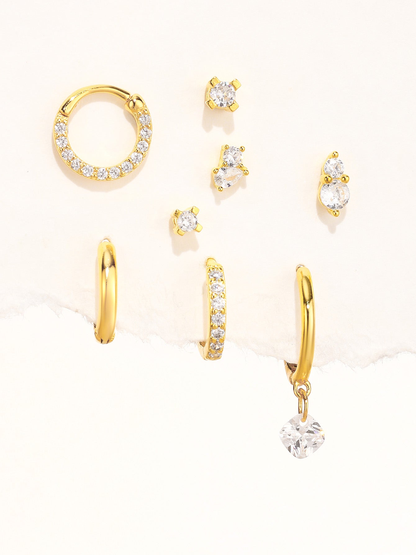 Collection of 925 sterling silver gold plated earrings featuring cubic zirconia stones, including hoops and studs.