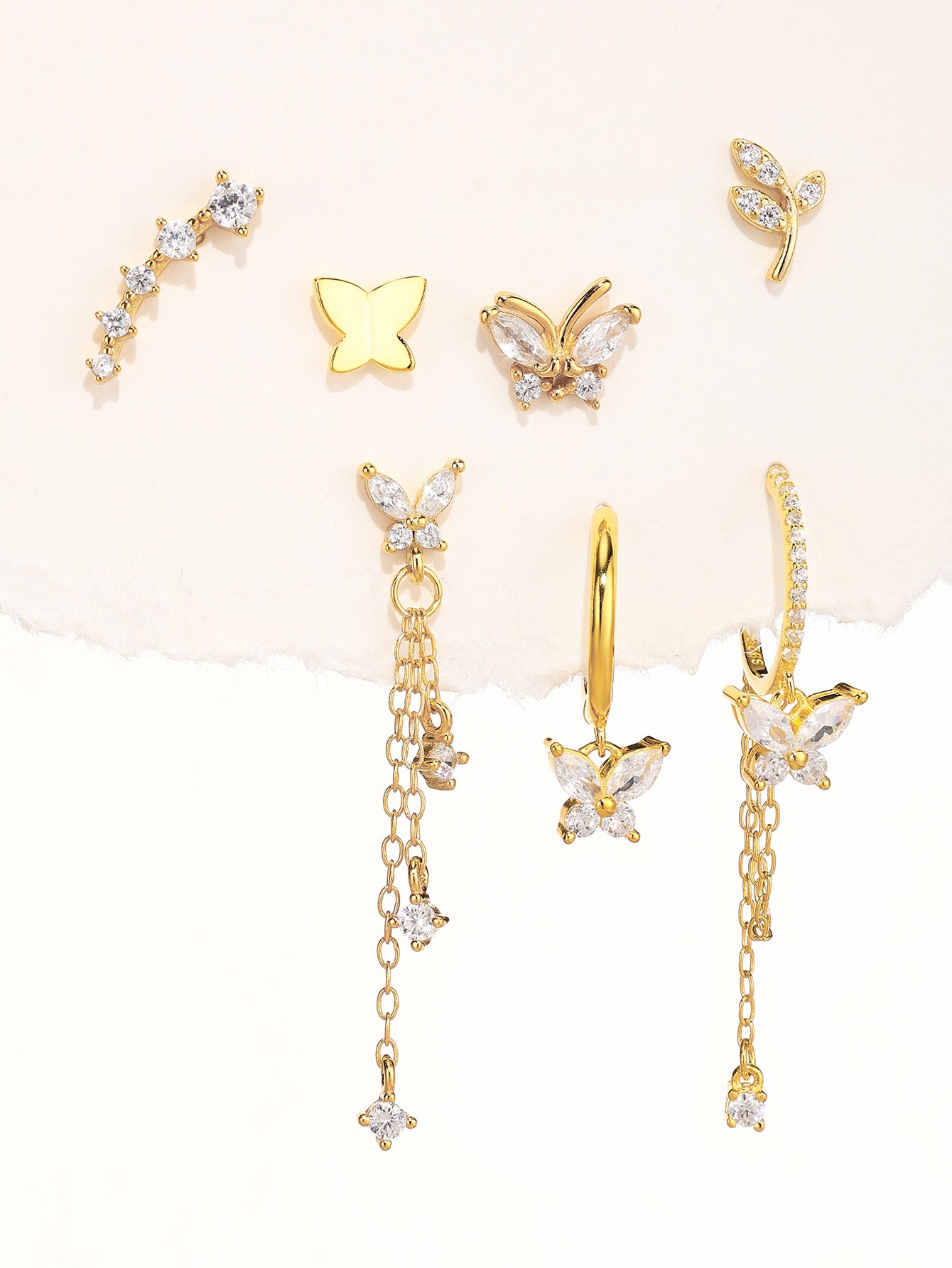 Collection of gold 925 sterling silver earrings with cubic zirconia and butterfly designs.