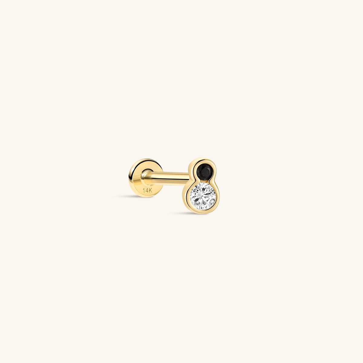 Side profile shot of KOSINER Puzzle 14K solid gold two-tone bezel flat back stud, internally threaded post stamped 14K, figure-8 shaped bezel setting with top black cz stone & larger clear round cz stone, modern black-white contrast cartilage piercing stud