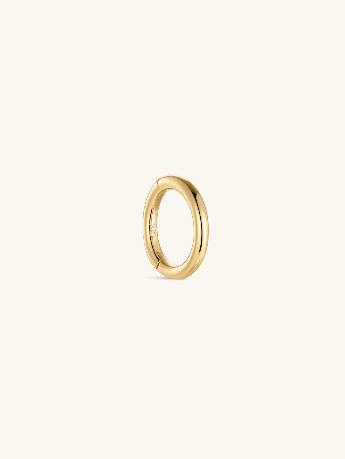 Single KOSINER 14K solid gold minimalist clicker hoop isolated on off-white background, engraved 14K marking on inner band, smooth polished round hinged piercing ring