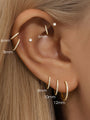 Gold-tone titanium cartilage hoop earrings with CZ stones, displayed on ear to show 6mm, 8mm, 10mm, and 12mm sizes.