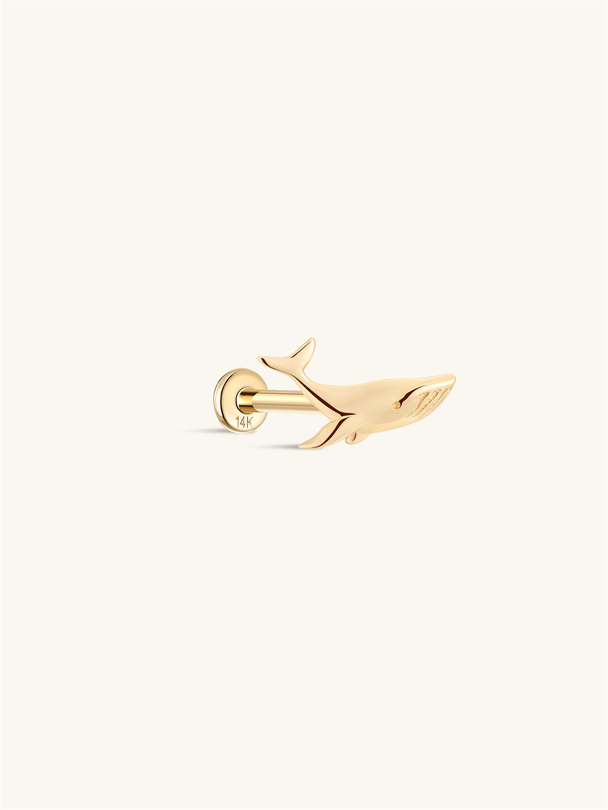 Side profile shot of KOSINER 14K solid gold whale flat back stud, internally threaded post stamped 14K, polished 3D whale silhouette with detailed texture on the body, cute ocean animal cartilage piercing stud