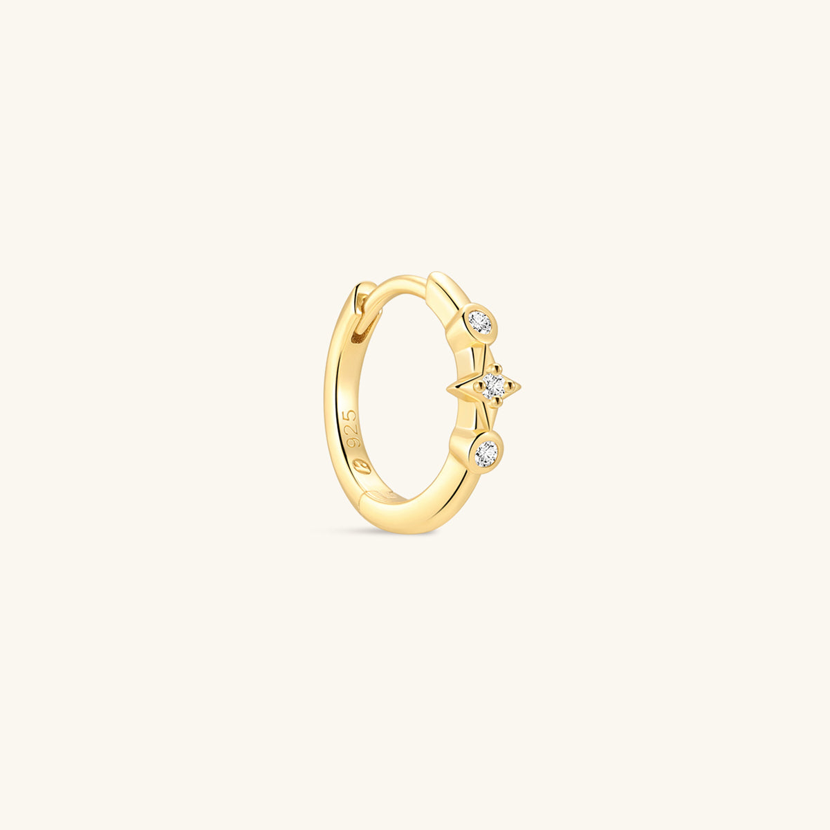 Pair of KOSINER Starlight minimalist hoop earrings front view, polished 925 sterling silver base plated in 18K gold vermeil, hinged clicker hoop detailed with central four-point star set with clear cubic zirconia, flanked by two round bezel-set CZ accents, inner band stamped 925 sterling silver marking