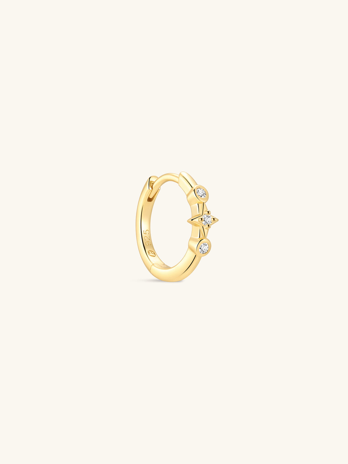 Pair of KOSINER Starlight minimalist hoop earrings front view, polished 925 sterling silver base plated in 18K gold vermeil, hinged clicker hoop detailed with central four-point star set with clear cubic zirconia, flanked by two round bezel-set CZ accents, inner band stamped 925 sterling silver marking