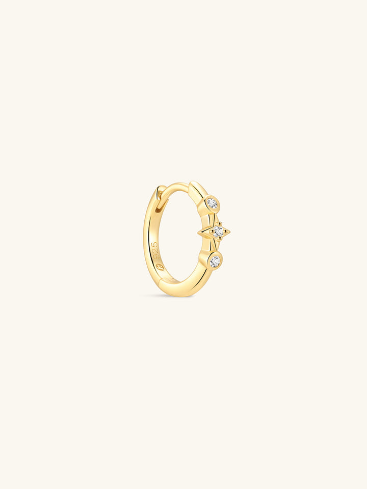 Pair of KOSINER Starlight minimalist hoop earrings front view, polished 925 sterling silver base plated in 18K gold vermeil, hinged clicker hoop detailed with central four-point star set with clear cubic zirconia, flanked by two round bezel-set CZ accents, inner band stamped 925 sterling silver marking