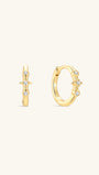 Pair of KOSINER Starlight minimalist hoop earrings front view, polished 925 sterling silver base plated in 18K gold vermeil, hinged clicker hoop detailed with central four-point star set with clear cubic zirconia, flanked by two round bezel-set CZ accents, inner band stamped 925 sterling silver marking
