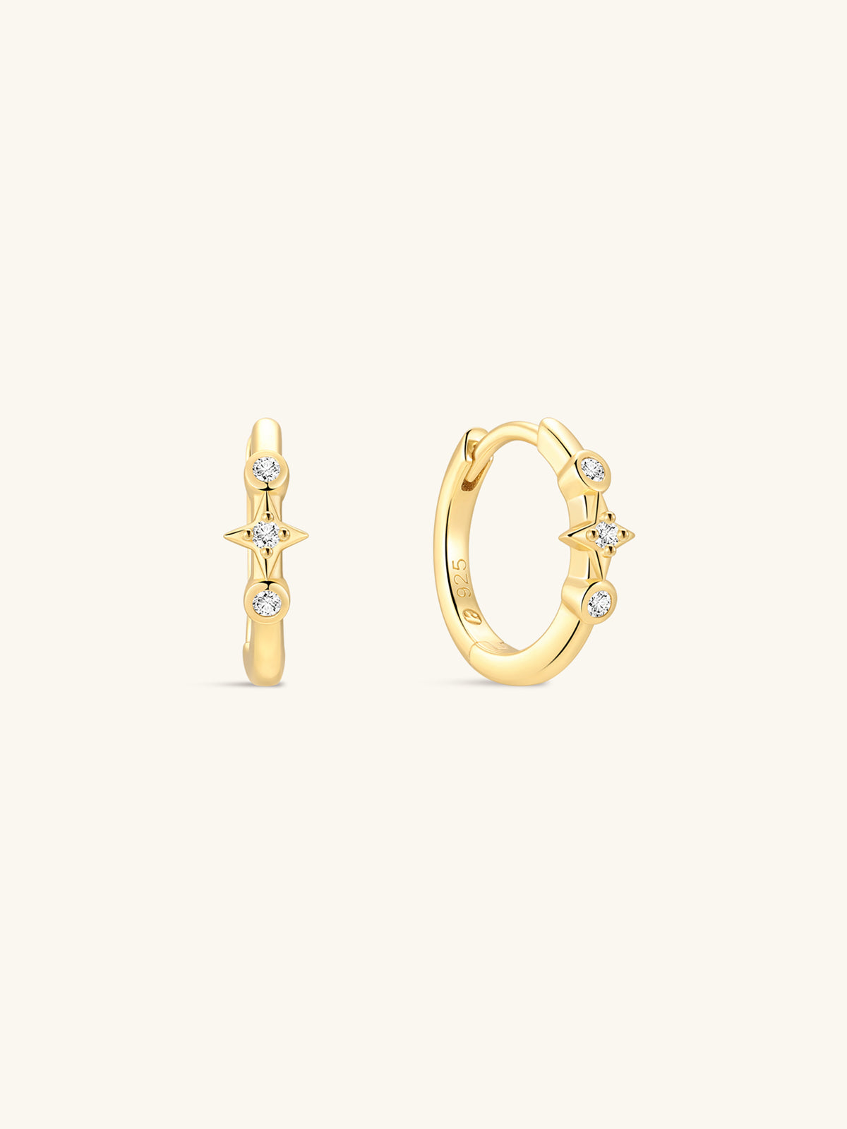 Pair of KOSINER Starlight minimalist hoop earrings front view, polished 925 sterling silver base plated in 18K gold vermeil, hinged clicker hoop detailed with central four-point star set with clear cubic zirconia, flanked by two round bezel-set CZ accents, inner band stamped 925 sterling silver marking