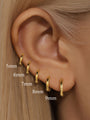 Gold 925 sterling silver hoop earrings in 5mm to 9mm sizes shown on ear, for size comparison.