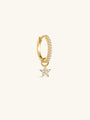 Close-up of KOSINER Rising Star gold-plated star dangle hoop styled with star studs and a curved upper-ear earring