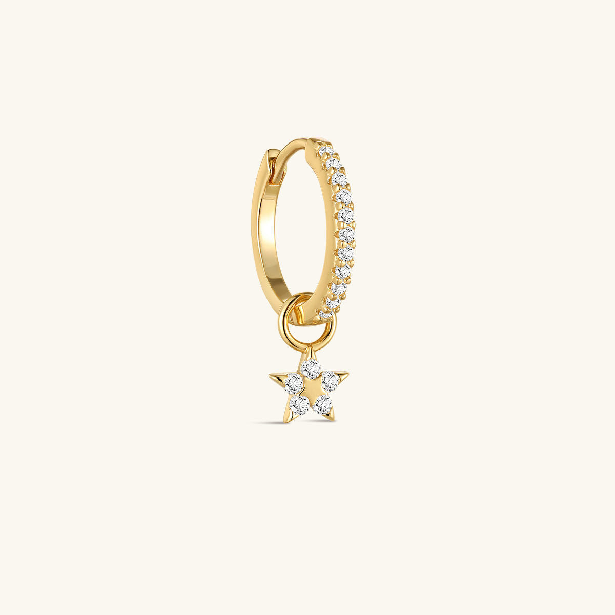 Close-up of KOSINER Rising Star gold-plated star dangle hoop styled with star studs and a curved upper-ear earring