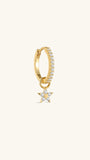 Close-up of KOSINER Rising Star gold-plated star dangle hoop styled with star studs and a curved upper-ear earring