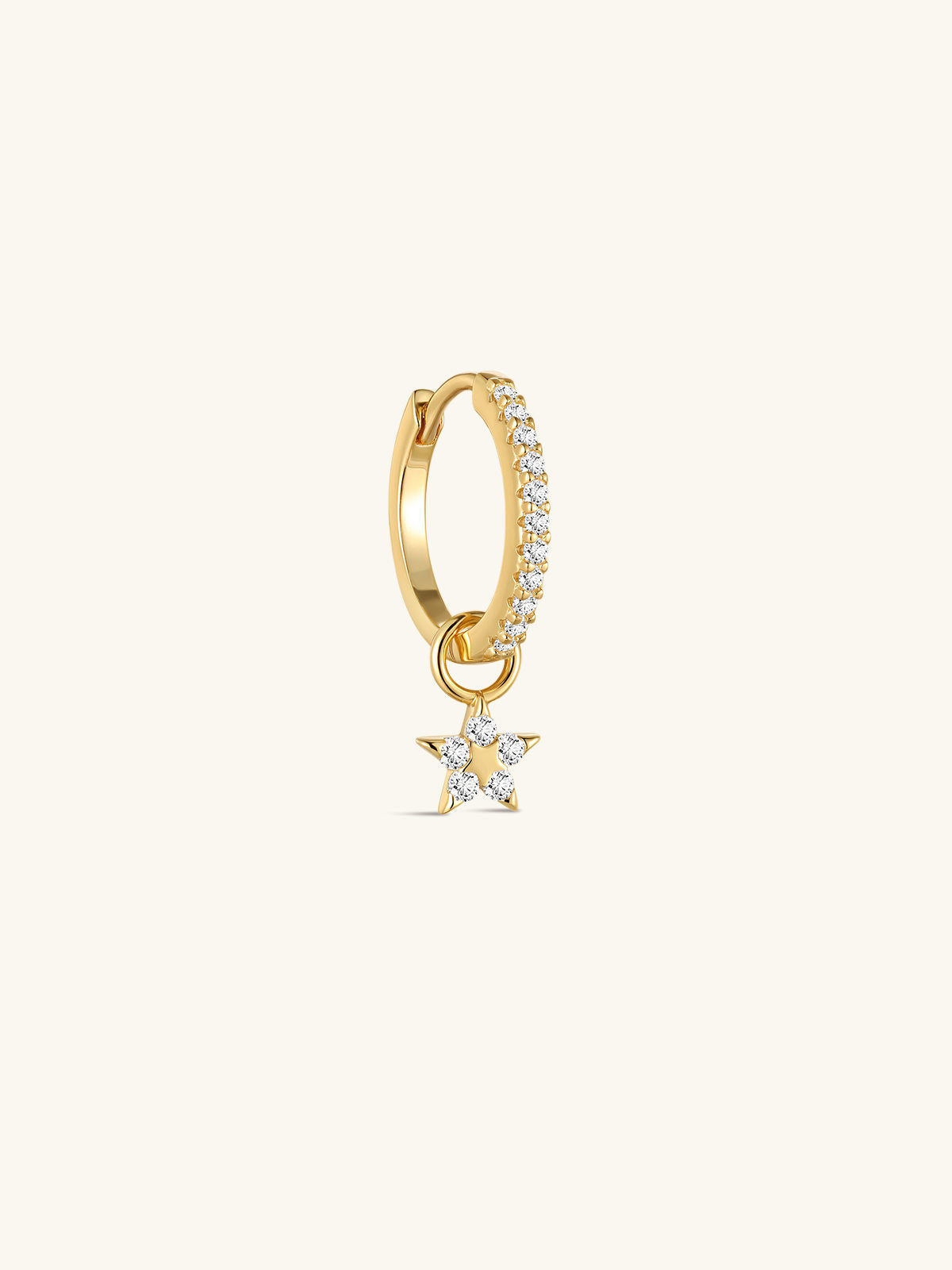 Close-up of KOSINER Rising Star gold-plated star dangle hoop styled with star studs and a curved upper-ear earring