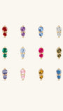 Complete 12-month dual birthstone flat back stud collection on off-white background, 14K gold prong-set two-stone design, each row corresponds to a monthly birthstone CZ hue from January Garnet to December Tanzanite