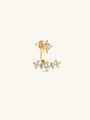 Close-up of KOSINER Rising Star gold-plated star stud and curved ear jacket styled with celestial earrings