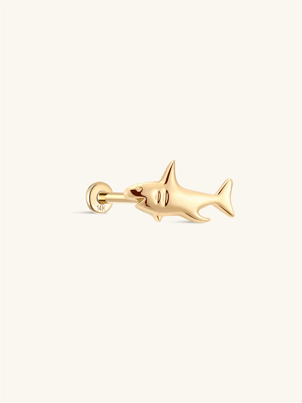 Side profile shot of KOSINER 14K solid gold shark flat back stud, internally threaded post stamped 14K, polished 3D shark silhouette with refined body detailing, playful marine animal cartilage piercing stud