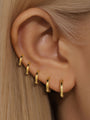 Gold plated 925 sterling silver hoop earrings in various sizes shown on ear, perfect for daily wear.