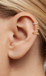 Close-up ear stacking photo showing KOSINER 14K solid gold C-shape flat back stud worn on helix piercing, paired with pave crystal matching style for delicate layered cartilage ear styling