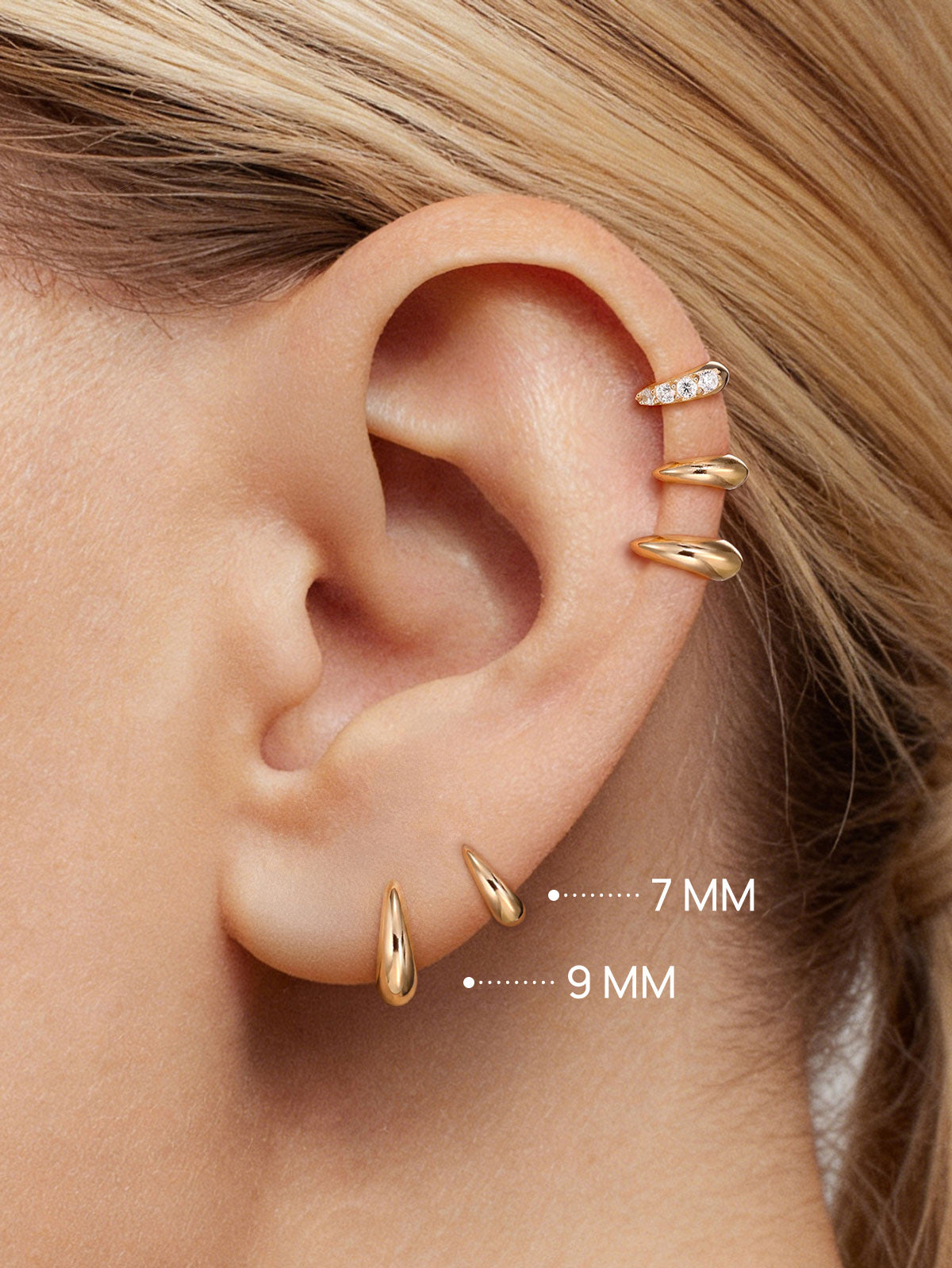 Close-up ear stacking photo showing KOSINER 14K solid gold C-shape flat back stud worn on helix piercing, paired with pave crystal matching style for delicate layered cartilage ear styling