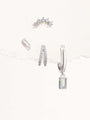 Collection of 925 sterling silver earrings with cubic zirconia: curved stud, baguette stud, pavé hoops, and drop earring.