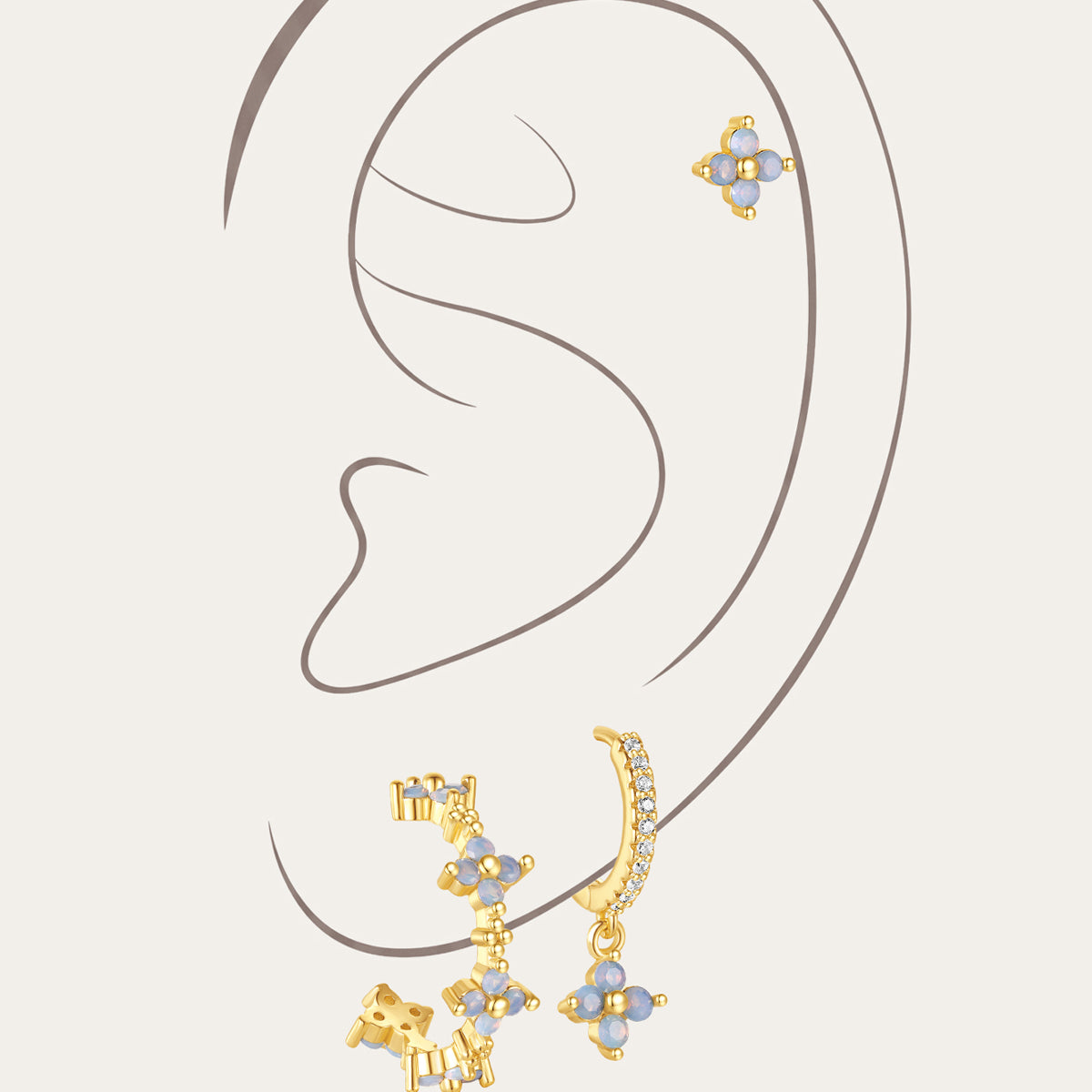 Set of 3 gold-plated sterling silver earrings with light blue floral cubic zirconia stones and micro-paved crystals.