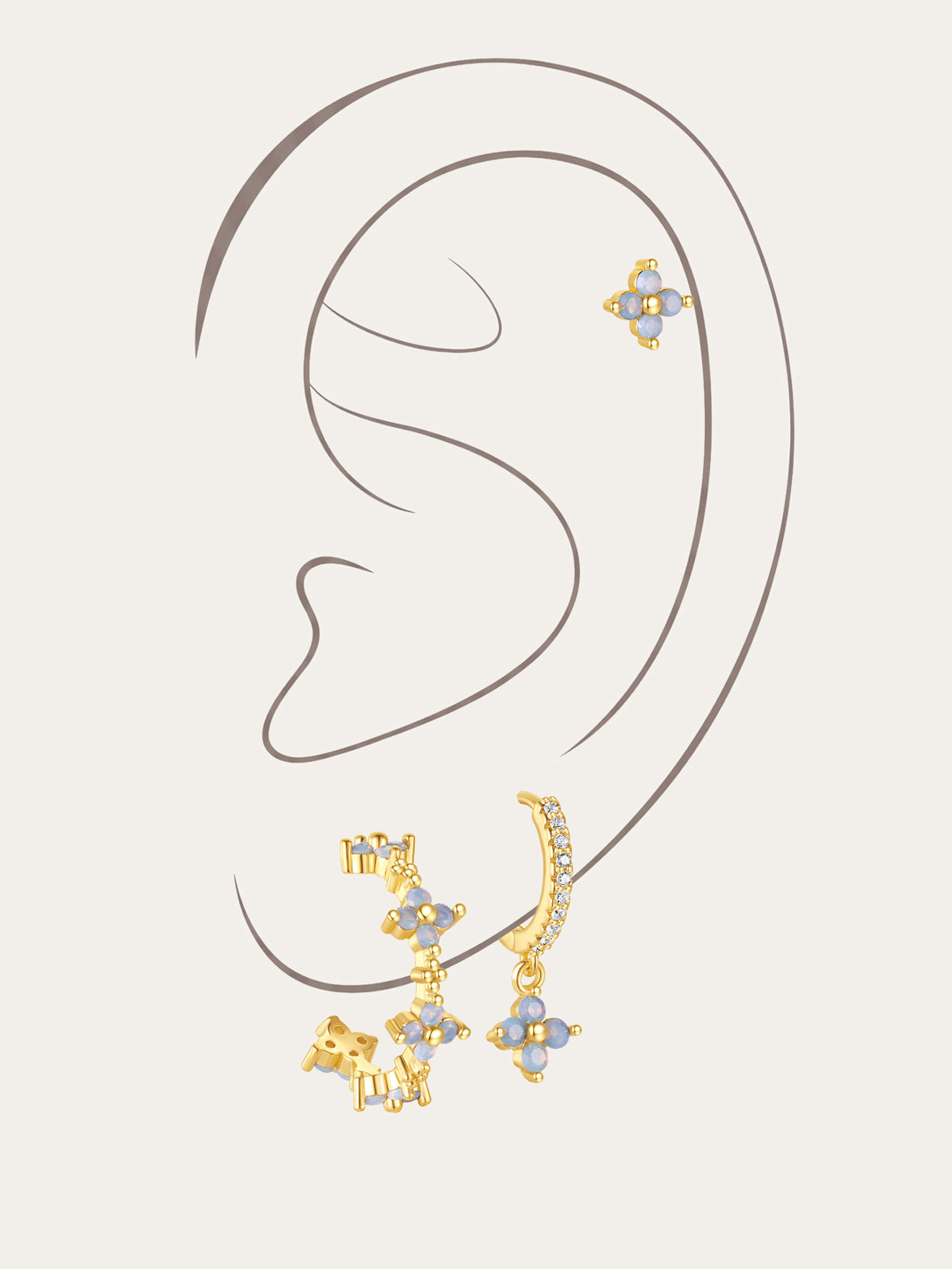 Set of 3 gold-plated sterling silver earrings with light blue floral cubic zirconia stones and micro-paved crystals.